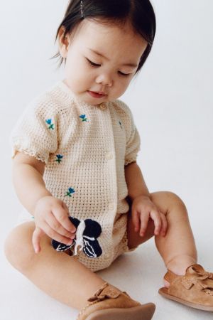 EMBROIDERED FLORAL TEXTURED ROMPER WITH LACE TRIM